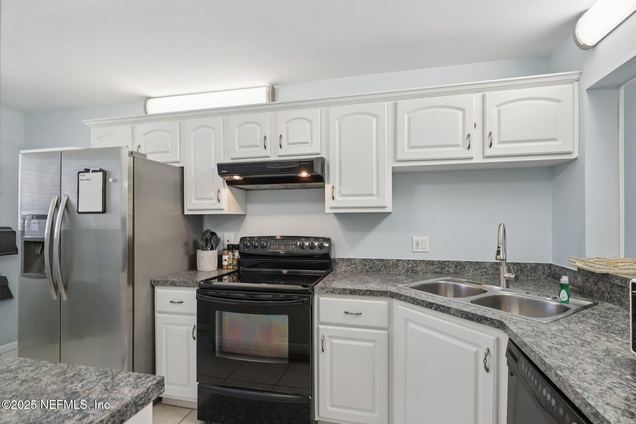 3801 Crown Point Road, Unit 1263 Jacksonville, FL 32257 - Photo 8 of 33 a kitchen with granite countertop a refrigerator and a sink