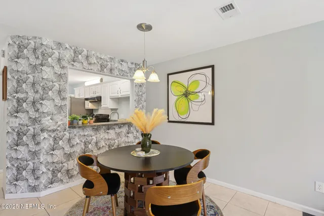 a view of a dining room with furniture and chandelier