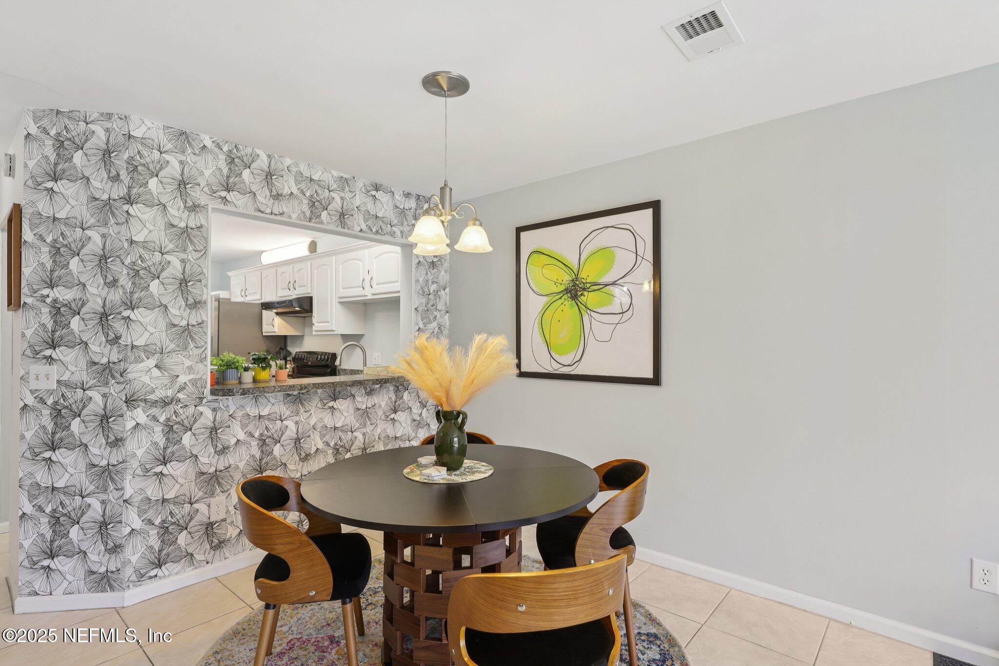 3801 Crown Point Road, Unit 1263 Jacksonville, FL 32257 - Photo 10 of 33 a view of a dining room with furniture and chandelier
