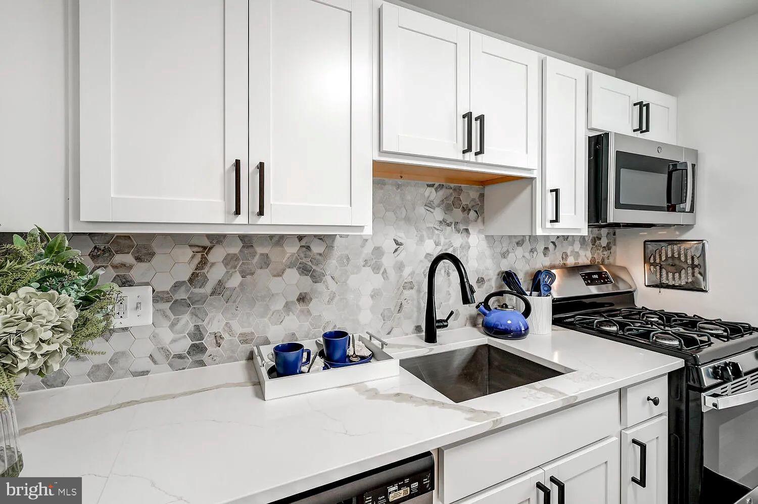 4014 Linkwood Road, Unit D Baltimore, MD 21210 - Photo 4 of 18 a kitchen with a sink a stove and cabinets