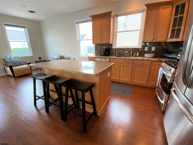 a kitchen with a table chairs sink and cabinets