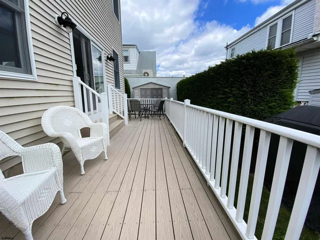 a view of balcony with wooden floor and fence
