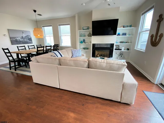 a living room with furniture fireplace and a flat screen tv