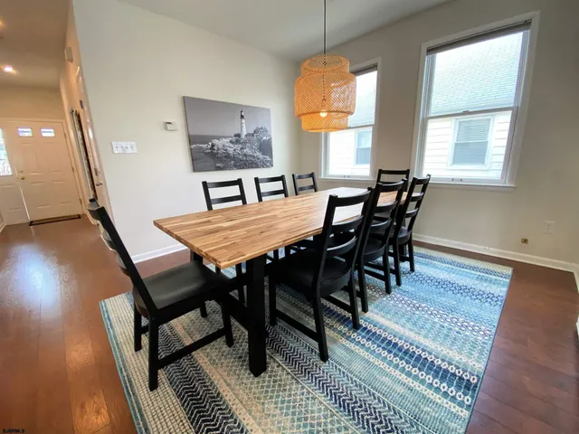 a view of a dining room with furniture and a window