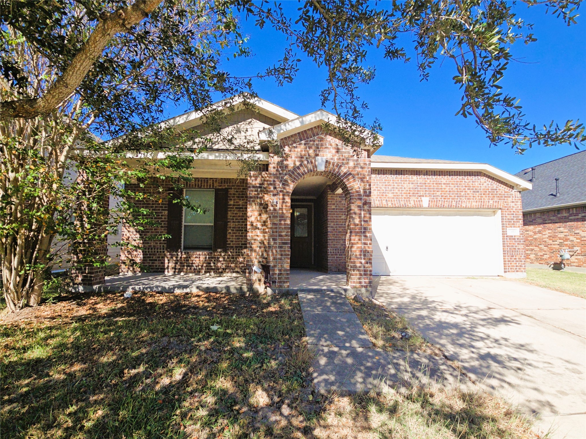 a view of a house with a tree in front of it
