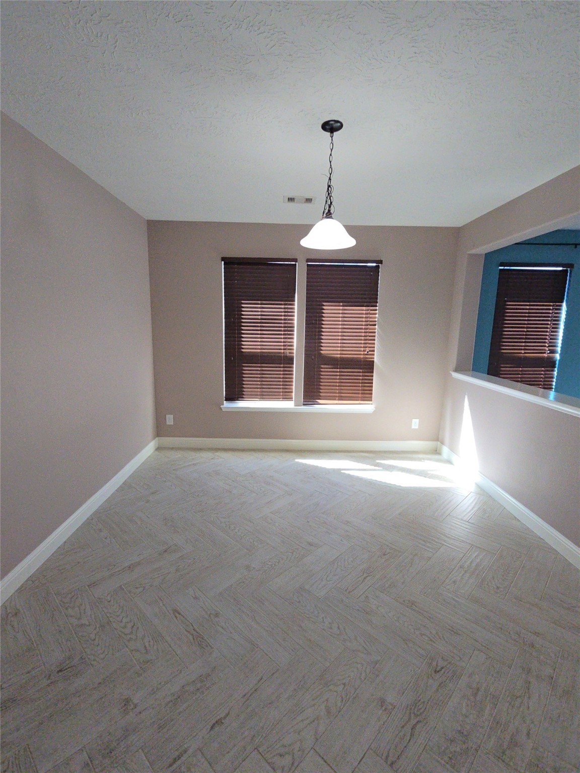 16014 Peach Bluff Lane Cypress, TX 77429 - Photo 15 of 26 a view of an empty room with window and chandelier