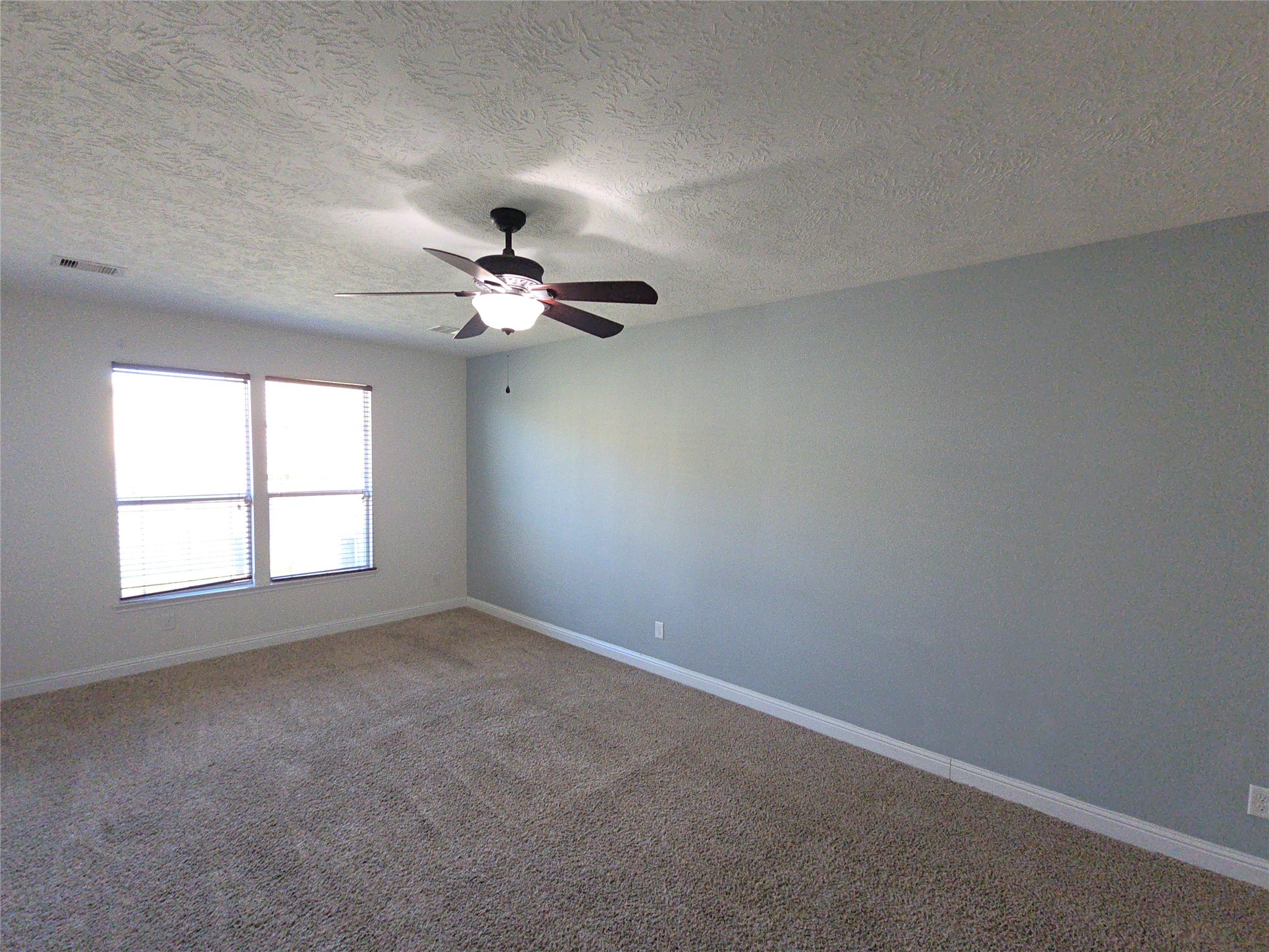 16014 Peach Bluff Lane Cypress, TX 77429 - Photo 5 of 26 an empty room with a window and a fan