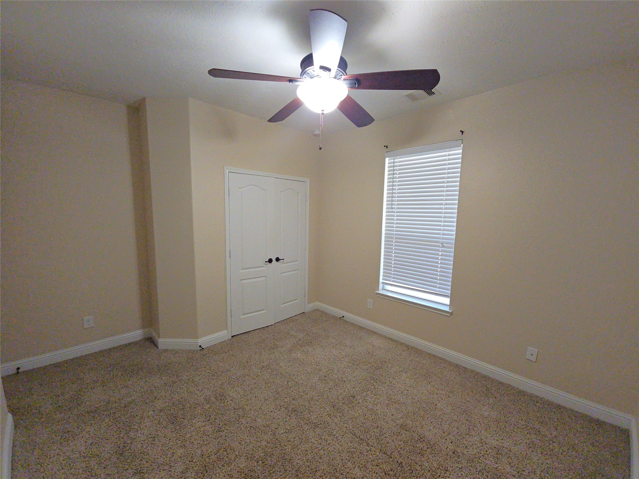 16014 Peach Bluff Lane Cypress, TX 77429 - Photo 9 of 26 an empty room with windows and fan