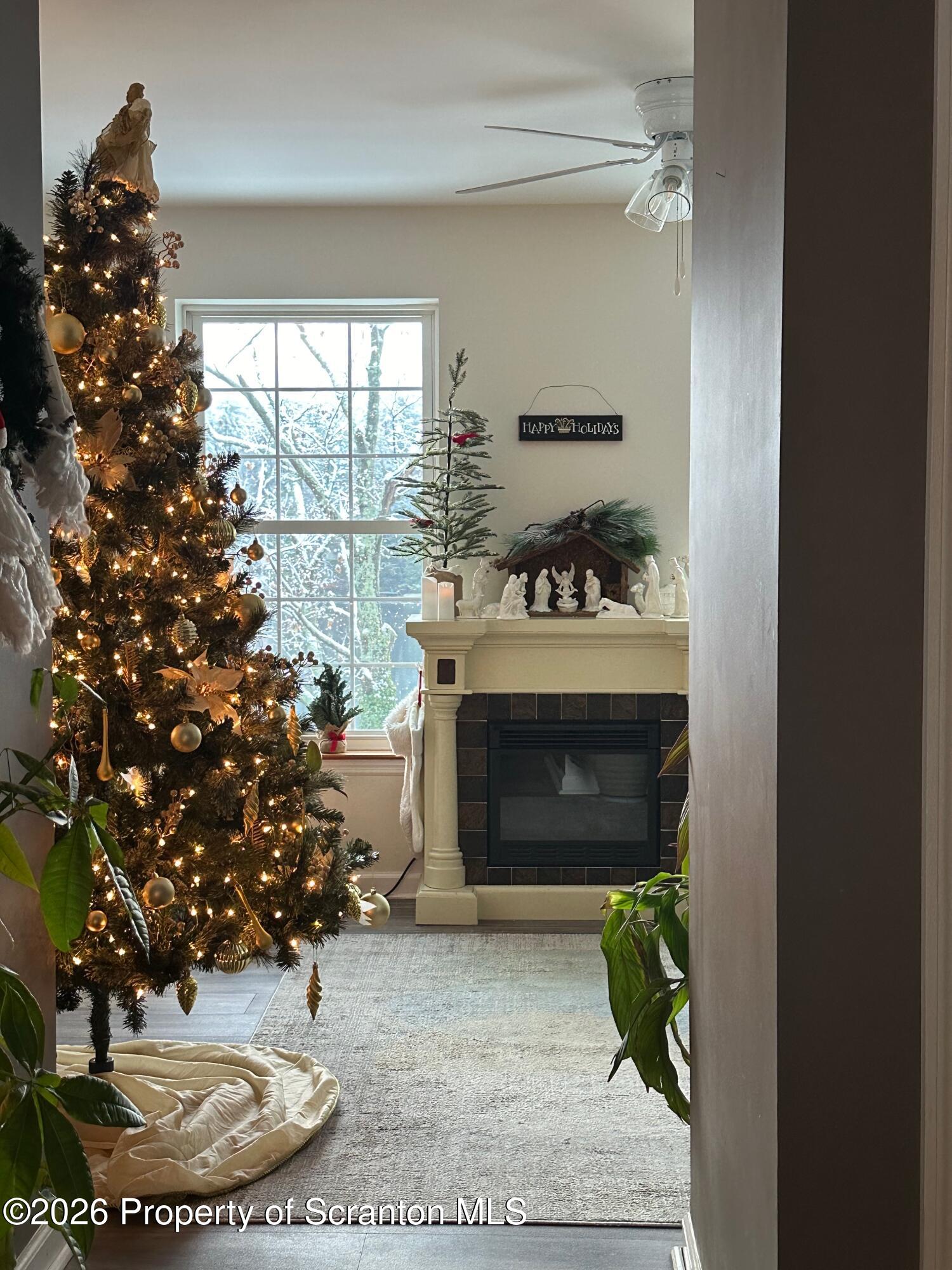 155 Baylor Road Nicholson, PA 18446 - Photo 52 of 53 a living room with a fireplace and a potted plant