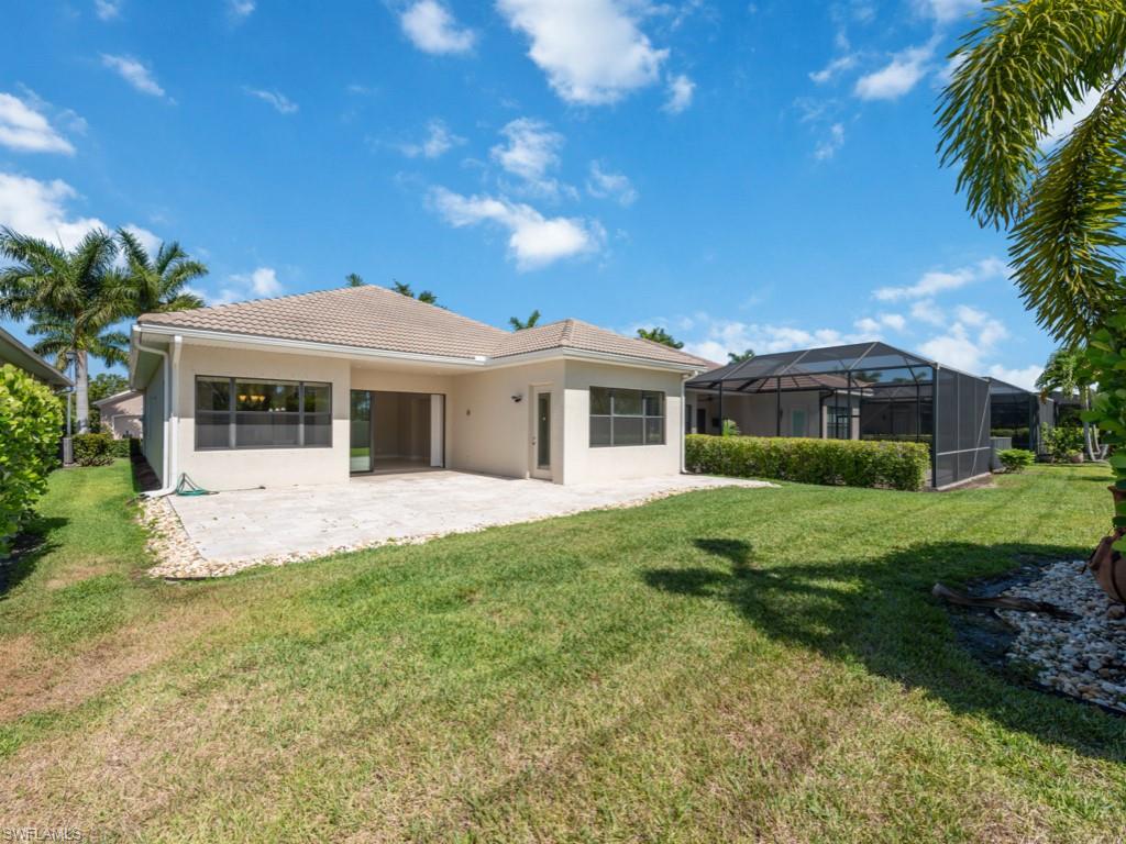 1638 Serrano Circle Naples, FL 34105 - Photo 14 of 23 a front view of a house with a yard