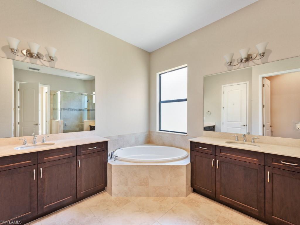 1638 Serrano Circle Naples, FL 34105 - Photo 16 of 23 a bathroom with a double vanity sink mirror and toilet