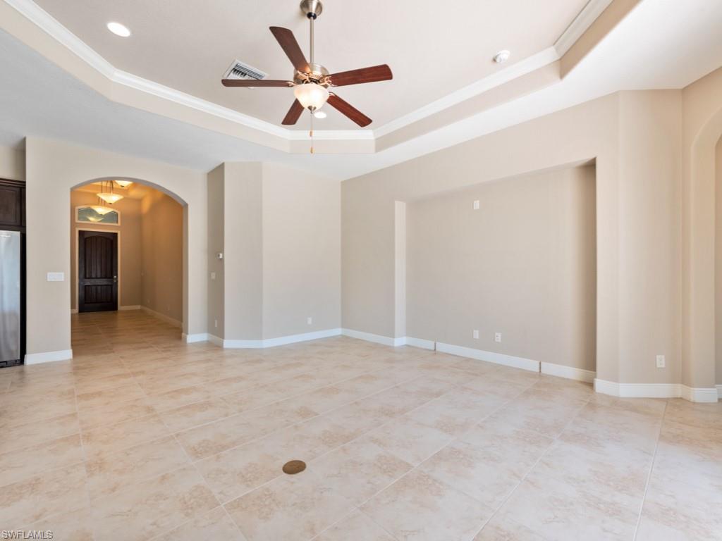 1638 Serrano Circle Naples, FL 34105 - Photo 10 of 23 an empty room with a ceiling fan and a bathroom