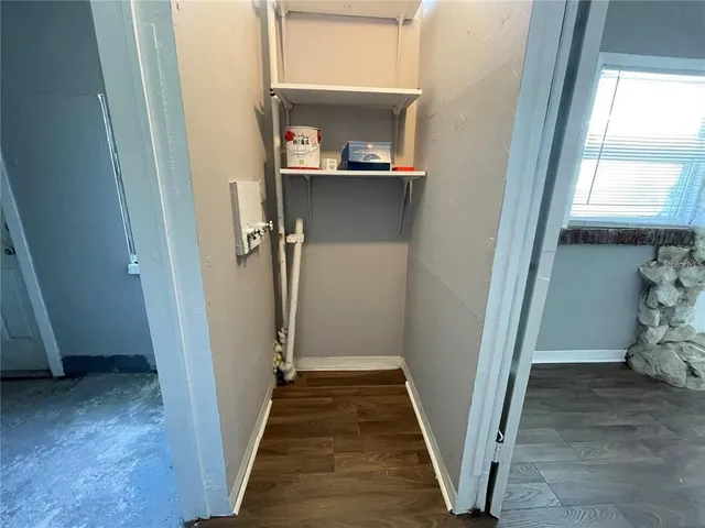 a view of a hallway view with wooden floor and staircase