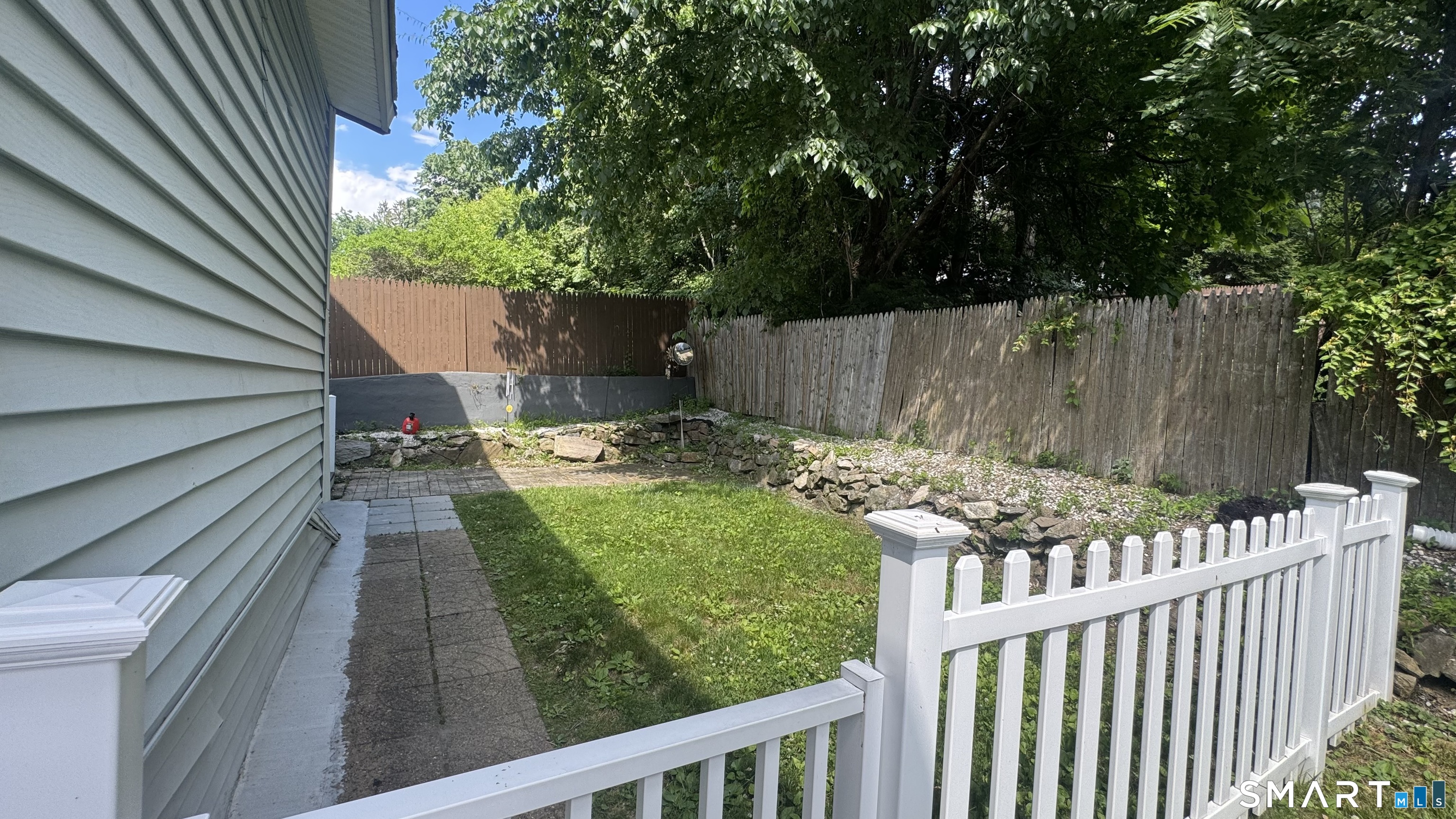 104 Prospect Street Ansonia, CT 06401 - Photo 9 of 40 a view of a backyard with a small cabin and wooden fence