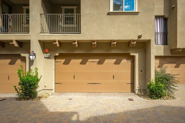 a view of a white house with a swimming pool and a yard