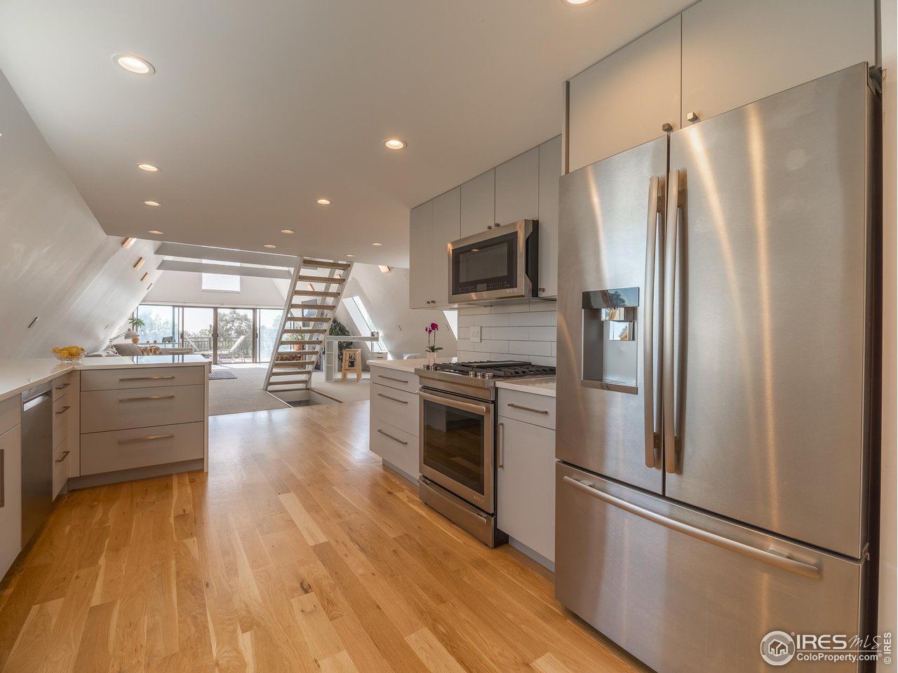 8423 Middle Fork Road Boulder, CO 80302 - Photo 12 of 40 a kitchen with stainless steel appliances a refrigerator a stove top oven and sink
