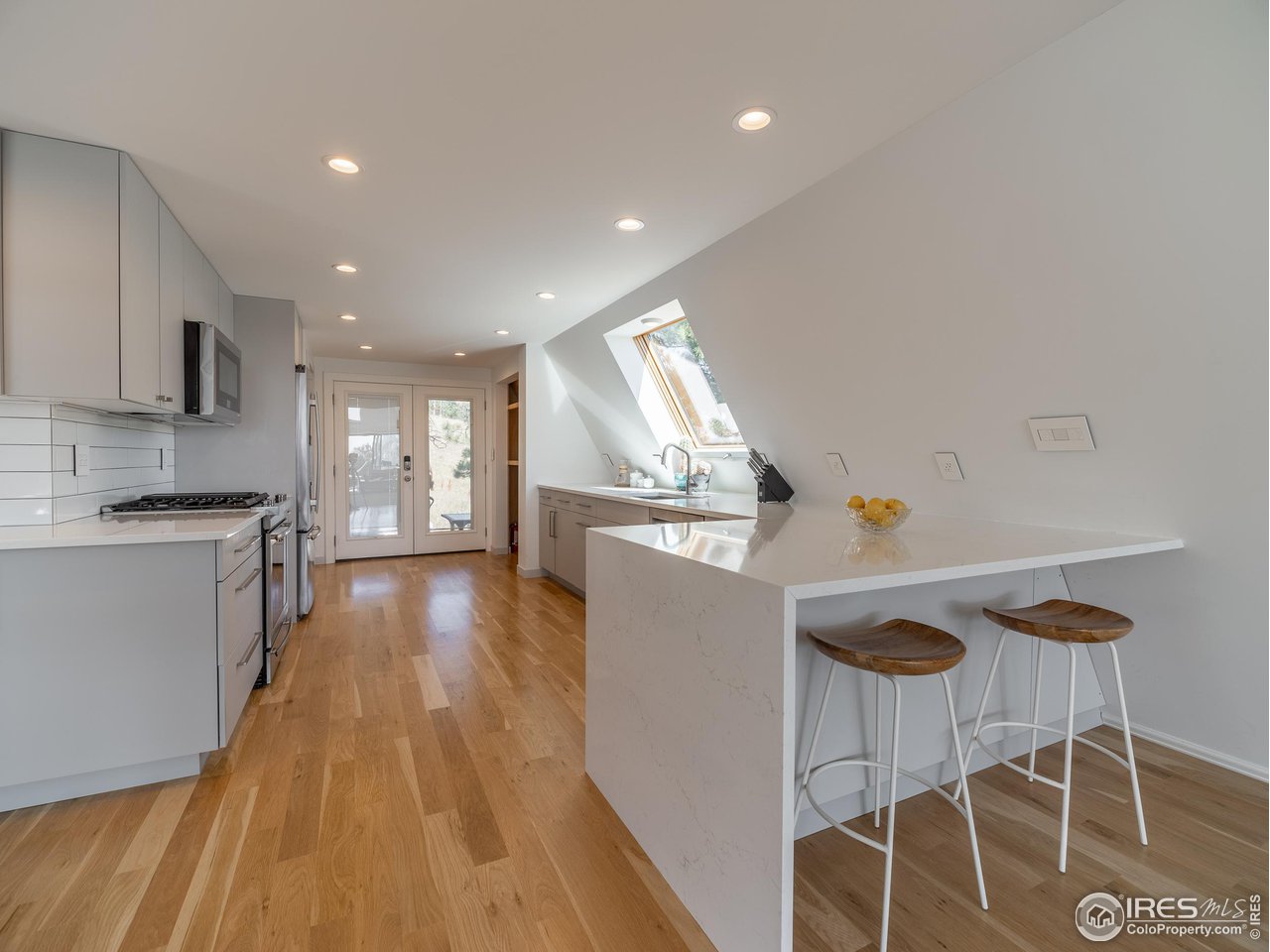 8423 Middle Fork Road Boulder, CO 80302 - Photo 14 of 40 a kitchen with kitchen island a counter top space a sink stainless steel appliances and cabinets