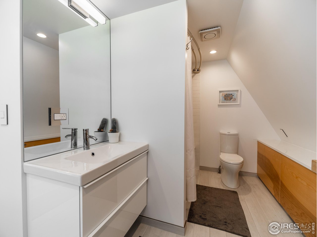 8423 Middle Fork Road Boulder, CO 80302 - Photo 18 of 40 a bathroom with a sink toilet and a mirror