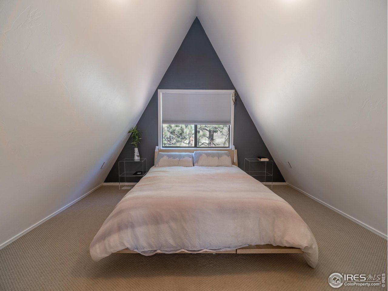 8423 Middle Fork Road Boulder, CO 80302 - Photo 22 of 40 a bed room with a bed and a window