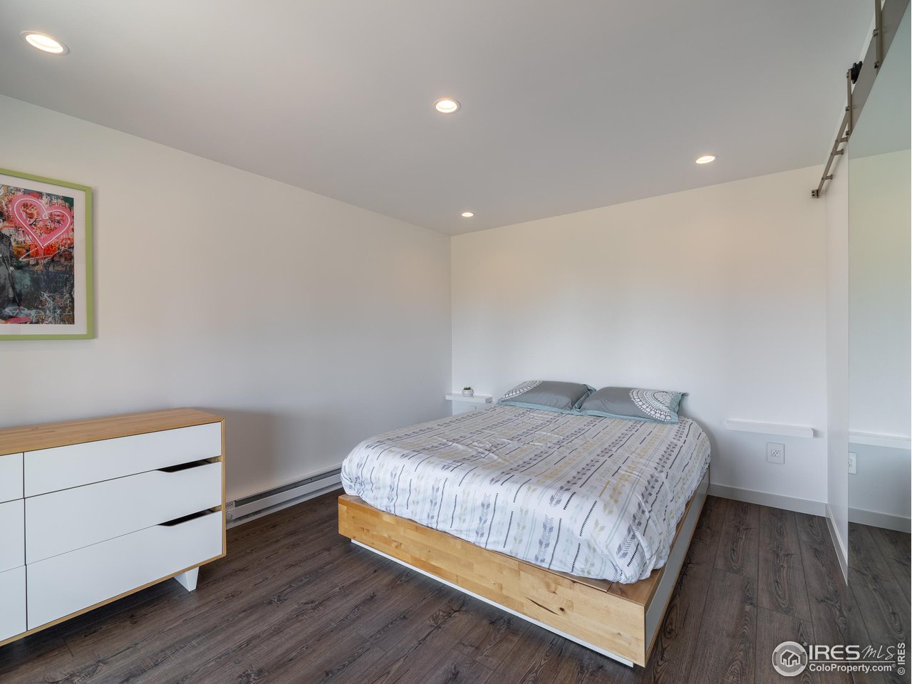 8423 Middle Fork Road Boulder, CO 80302 - Photo 30 of 40 a bedroom with a bed and a night stand