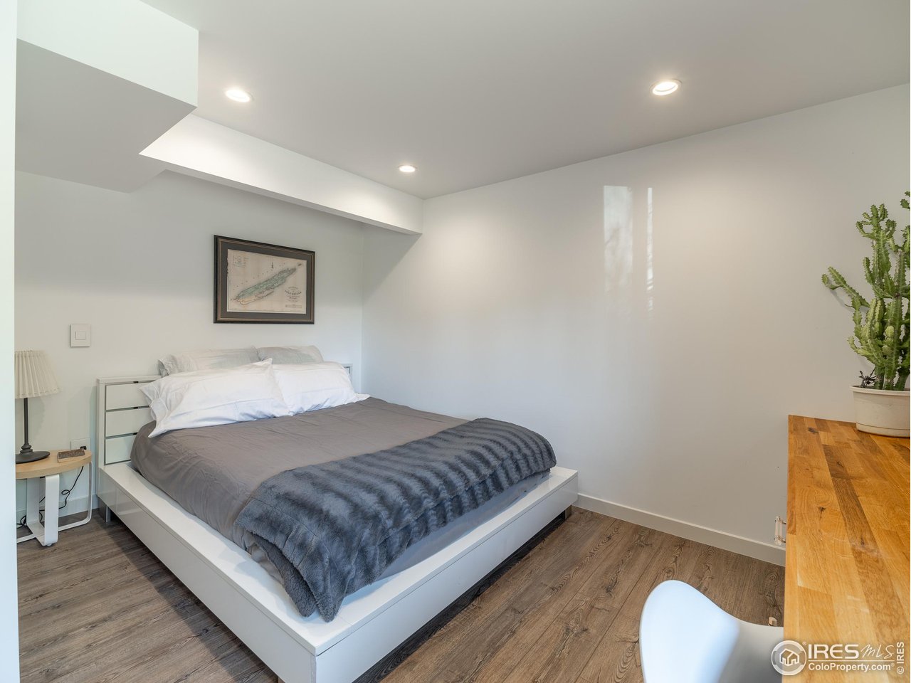 8423 Middle Fork Road Boulder, CO 80302 - Photo 32 of 40 a bedroom with a bed and painting on the wall