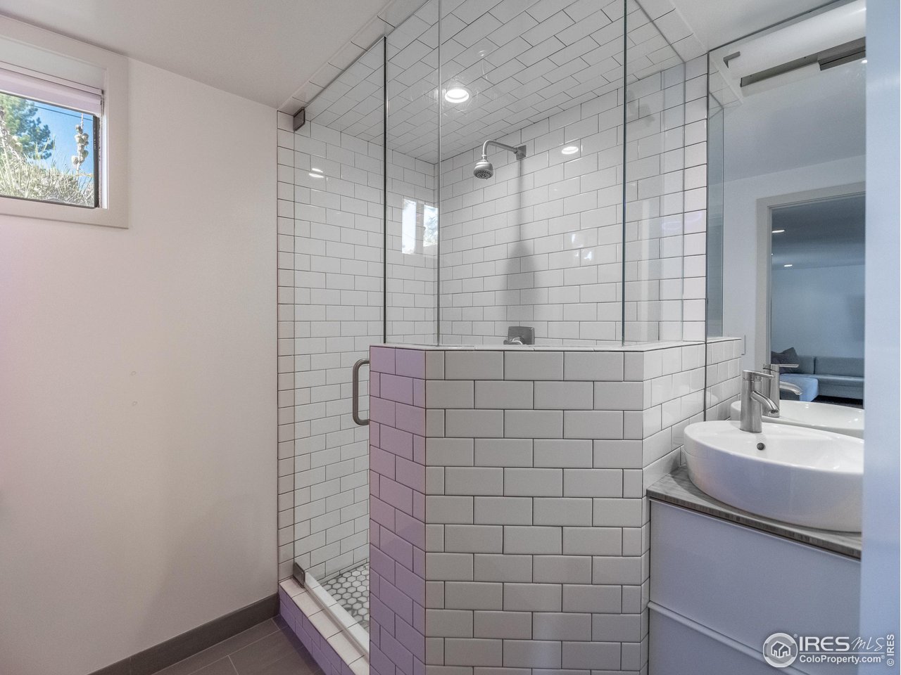 8423 Middle Fork Road Boulder, CO 80302 - Photo 34 of 40 a bathroom with a sink a shower and a mirror