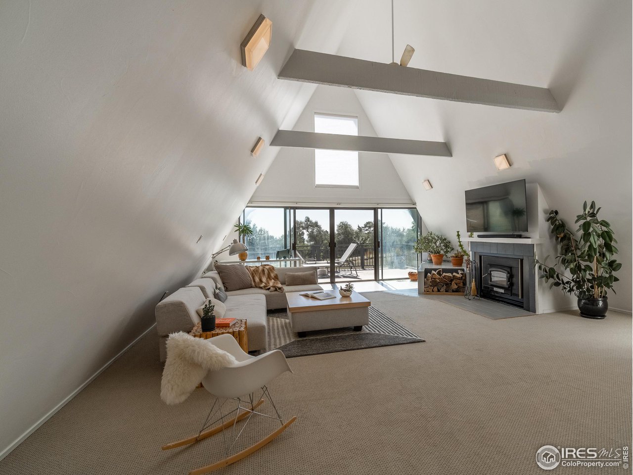 8423 Middle Fork Road Boulder, CO 80302 - Photo 5 of 40 a living room with furniture a fireplace and a large window