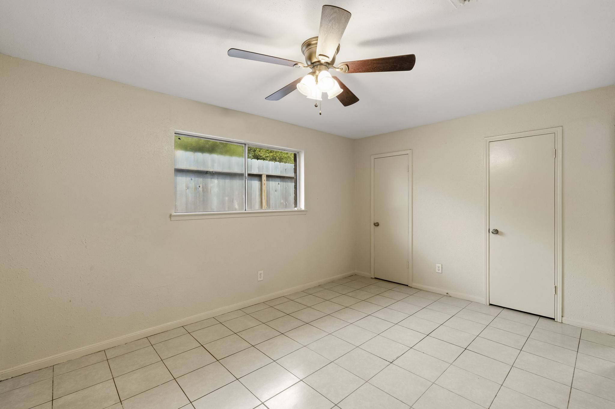 5315 Ridgestone Street Houston, TX 77053 - Photo 12 of 19 Primary bedroom with tile flooring, ceiling fan, and ample natural light.