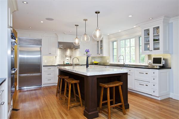 32 Arlington Road Wellesley, MA 02481 - Photo 10 of 29 a kitchen with stainless steel appliances granite countertop a table chairs stove and refrigerator