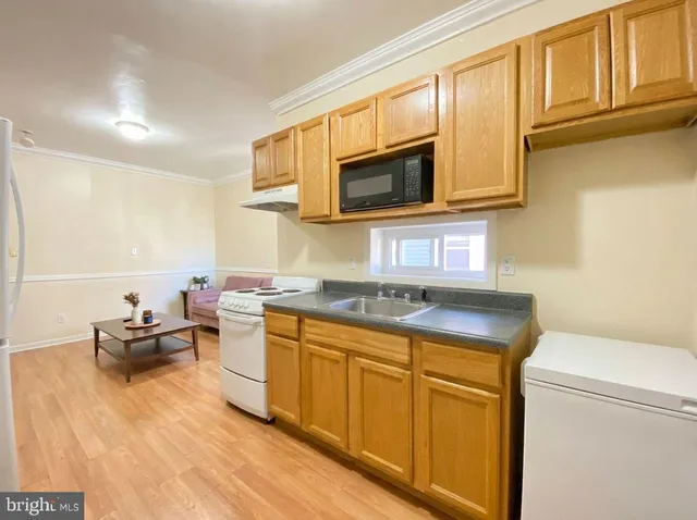 a kitchen with stainless steel appliances granite countertop a sink stove and microwave
