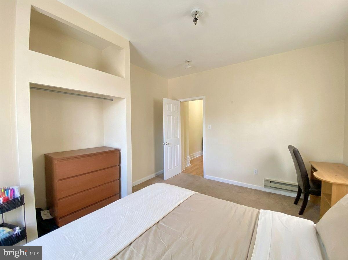 1849 North 17th Street, Unit 4 Philadelphia, PA 19121 - Photo 11 of 12 a bedroom with a bed and furniture