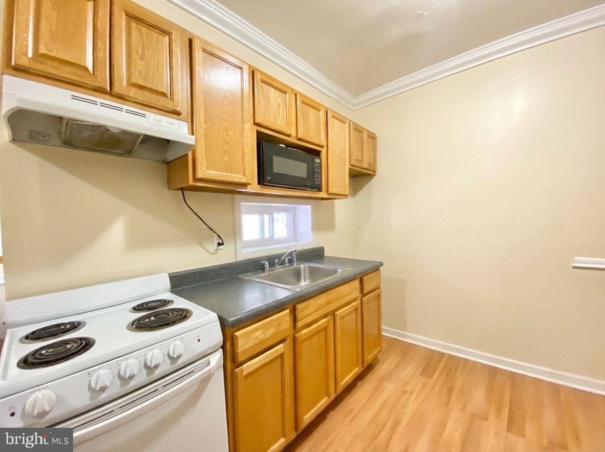 1849 North 17th Street, Unit 4 Philadelphia, PA 19121 - Photo 2 of 12 a kitchen with a sink a stove and cabinets
