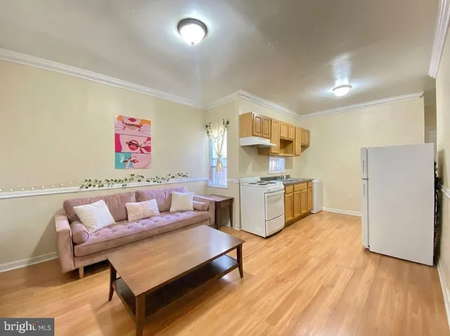 a living room with furniture and kitchen view