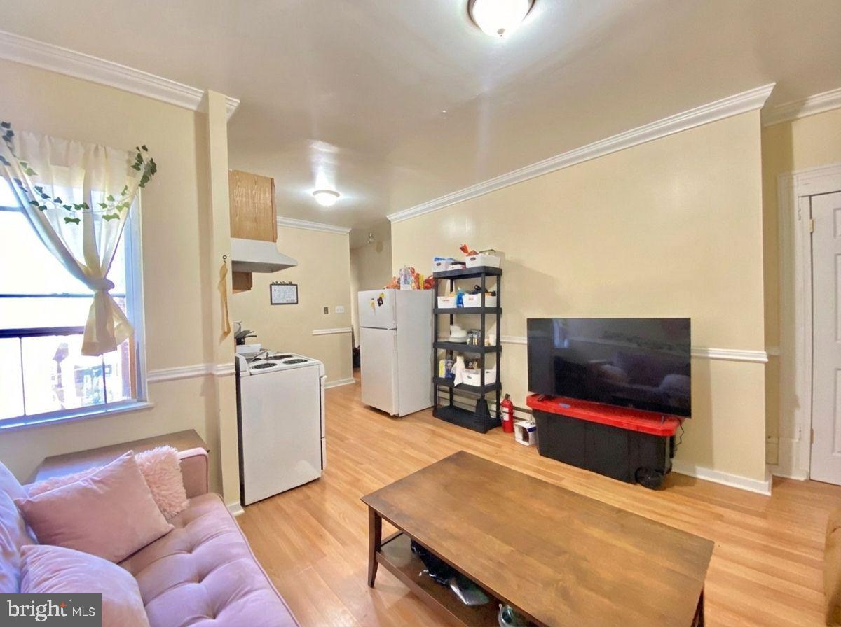 1849 North 17th Street, Unit 4 Philadelphia, PA 19121 - Photo 5 of 12 a living room with furniture and a flat screen tv