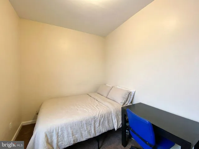 a bed sitting in a bedroom next to a window