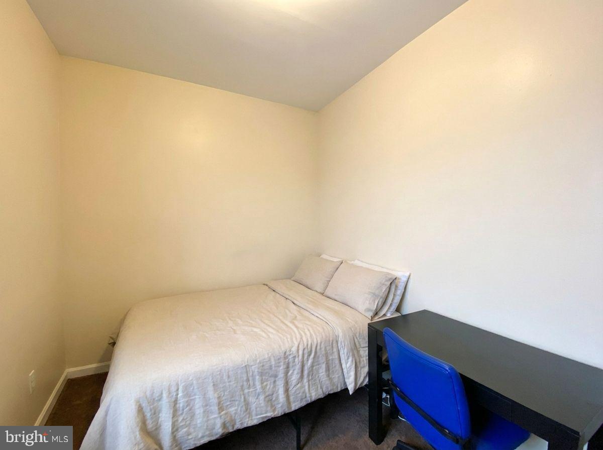 1849 North 17th Street, Unit 4 Philadelphia, PA 19121 - Photo 7 of 12 a bed sitting in a bedroom next to a window