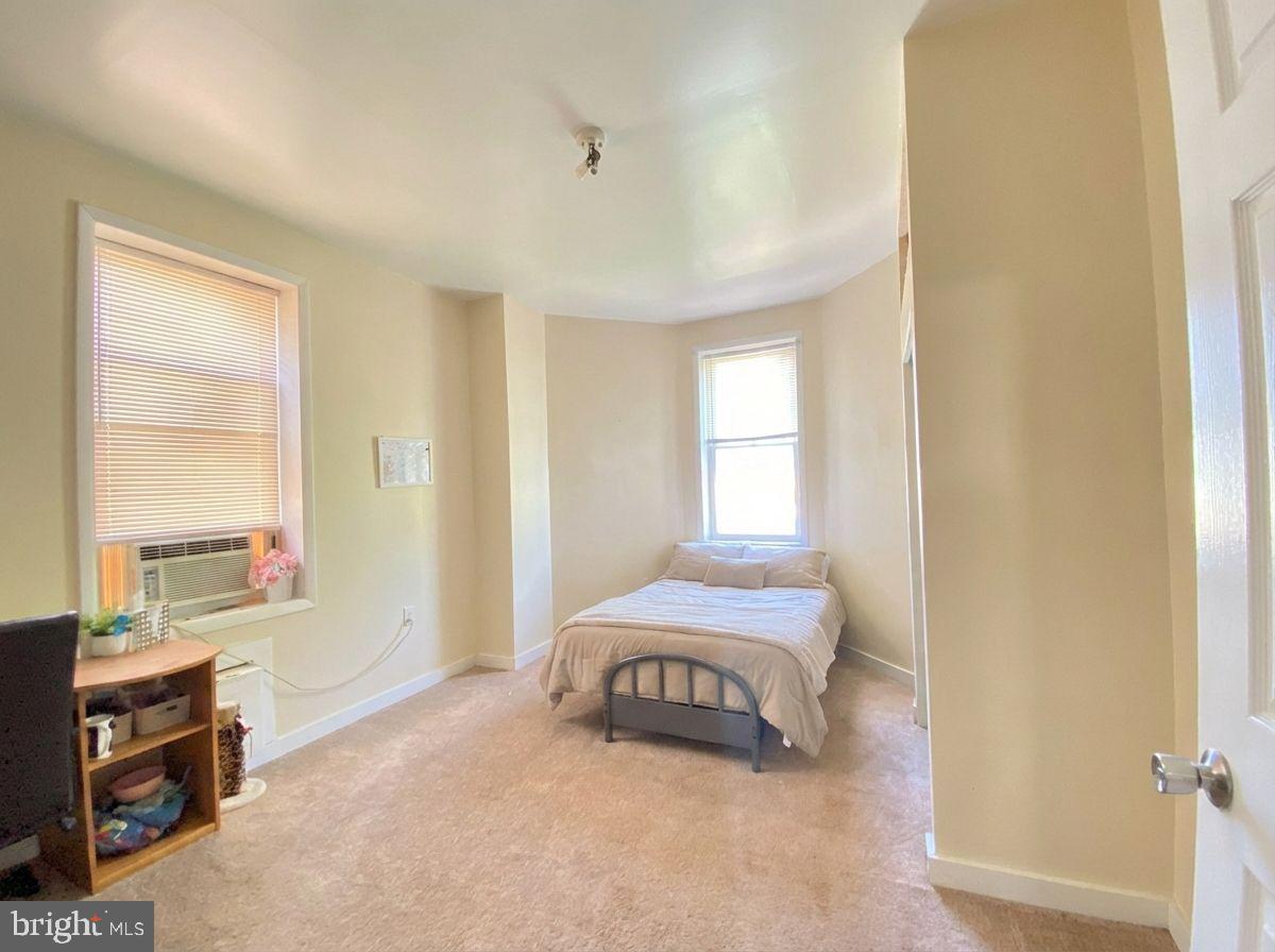 1849 North 17th Street, Unit 4 Philadelphia, PA 19121 - Photo 9 of 12 a bedroom with a bed and a window