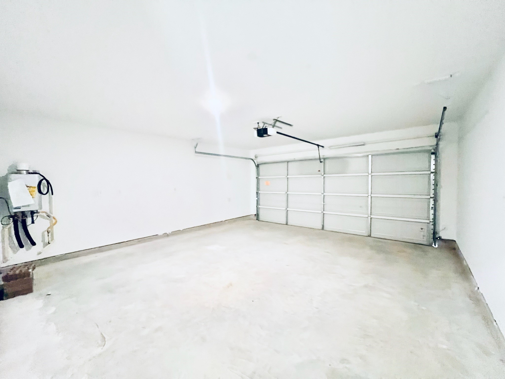 1359 Diamond Carnation Drive Conroe, TX 77301 - Photo 13 of 14 Garage features a tankless water heater and remote garage door opener