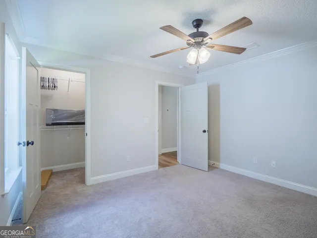 a view of an empty room with a fan