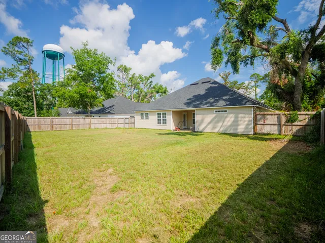 a house view with swimming pool and garden space