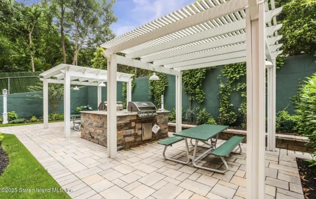 a view of a patio with a dining table and chairs