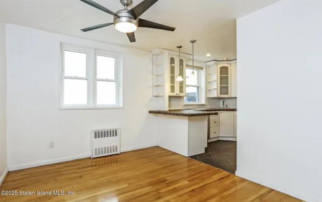 a view of kitchen with wooden floor and window