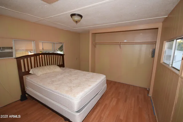 a bedroom with a bed and a window