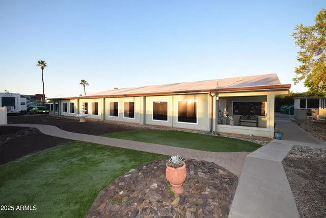 a front view of a house with a garden and yard