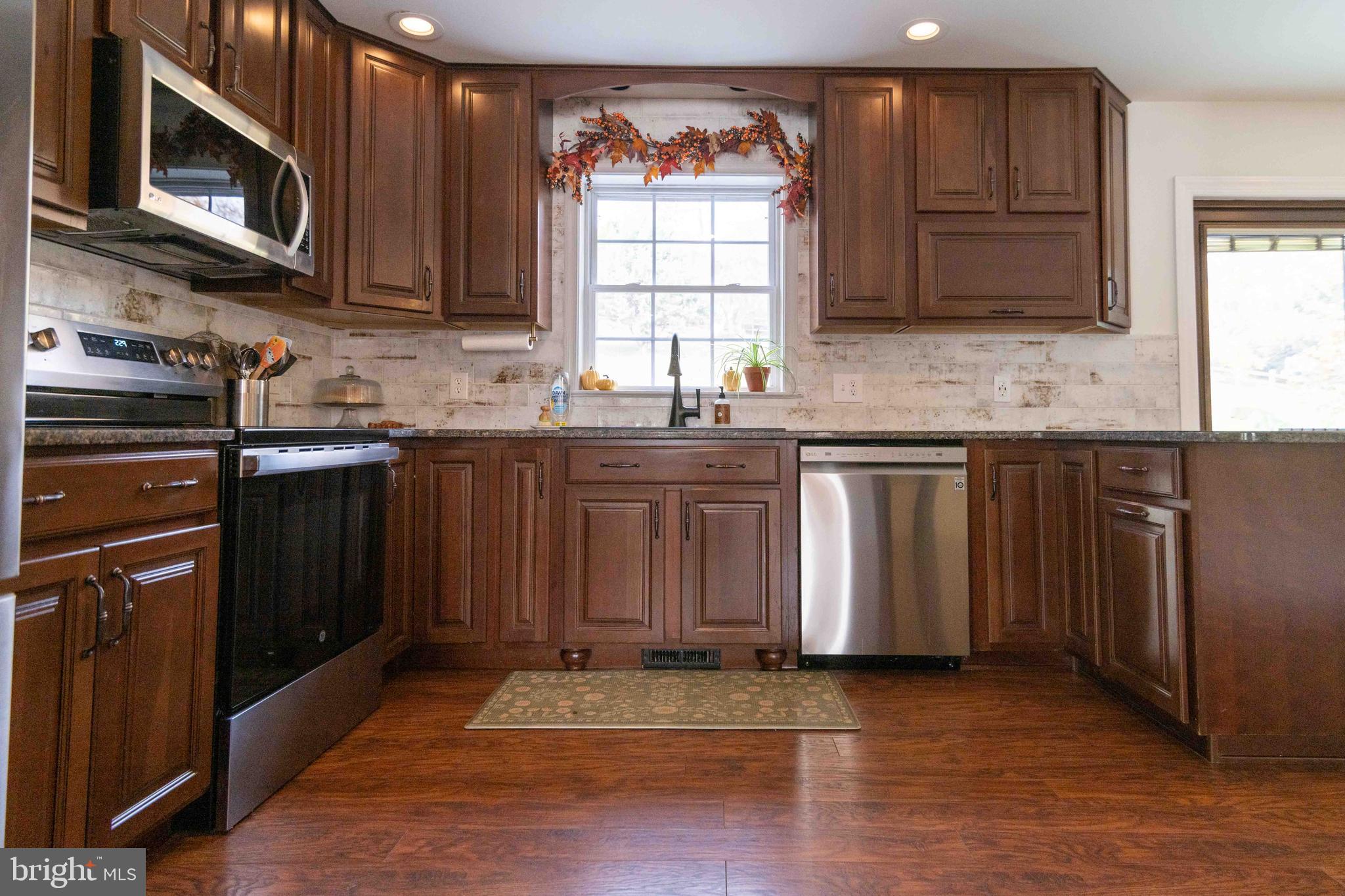 151 South Sandy Hill Road Coatesville, PA 19320 - Photo 12 of 91 a kitchen with stainless steel appliances granite countertop a stove a sink and a microwave