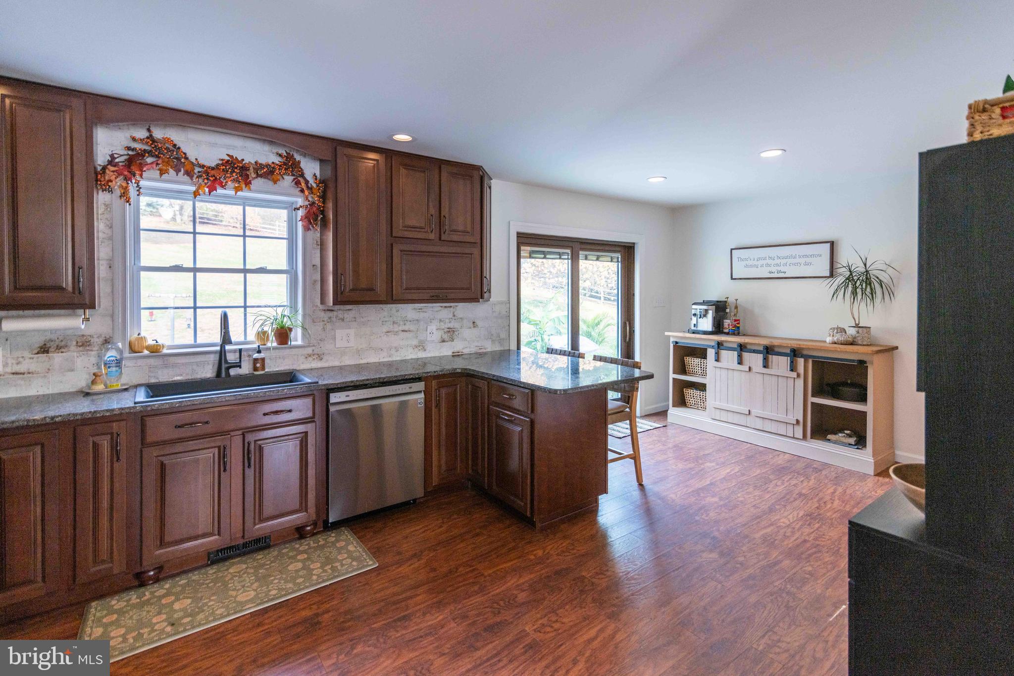 151 South Sandy Hill Road Coatesville, PA 19320 - Photo 15 of 91 a kitchen with stainless steel appliances granite countertop wooden cabinets a sink a stove a dining table and chairs