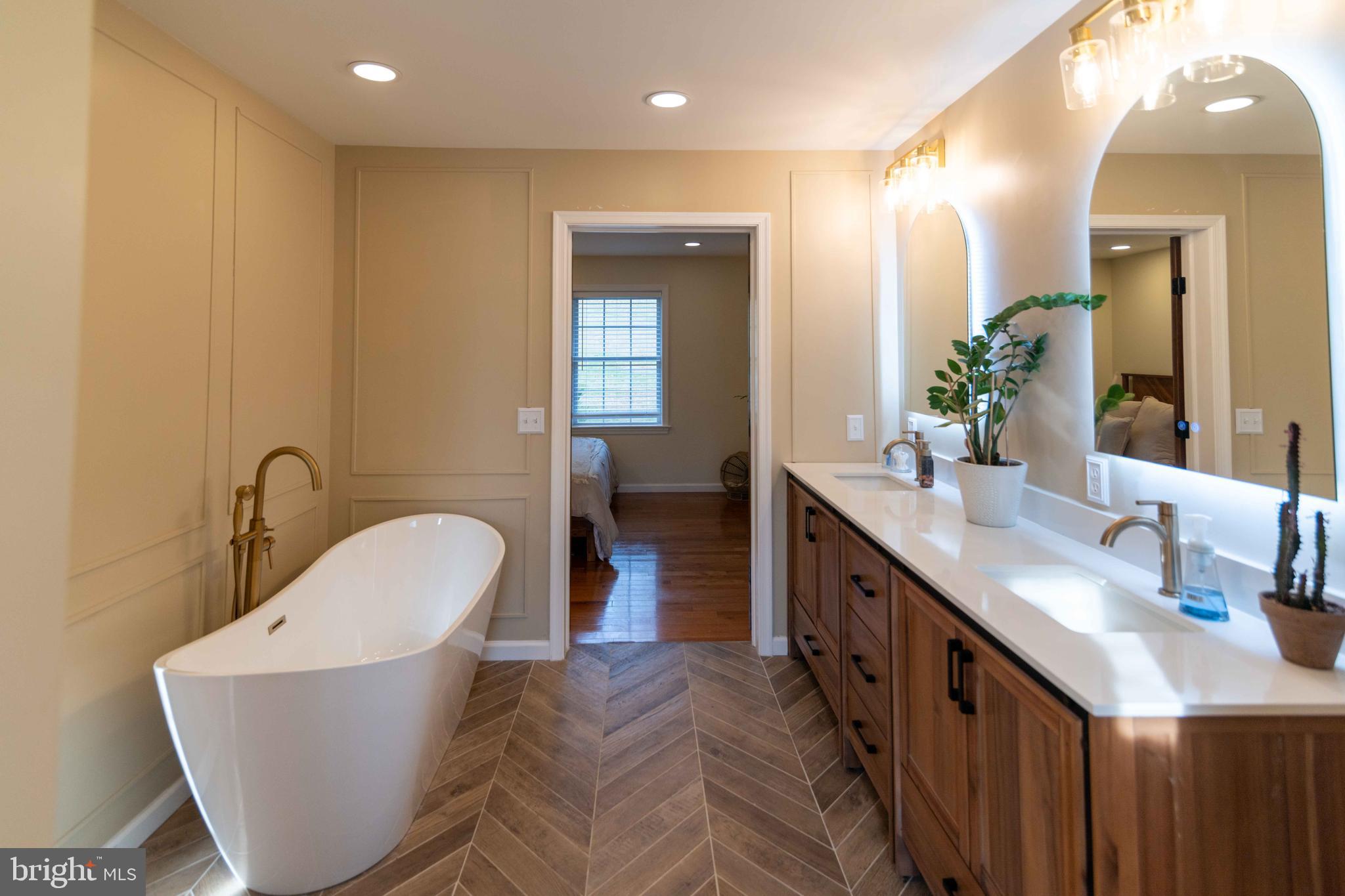 151 South Sandy Hill Road Coatesville, PA 19320 - Photo 39 of 91 a bathroom with a double vanity sink a mirror and a bathtub
