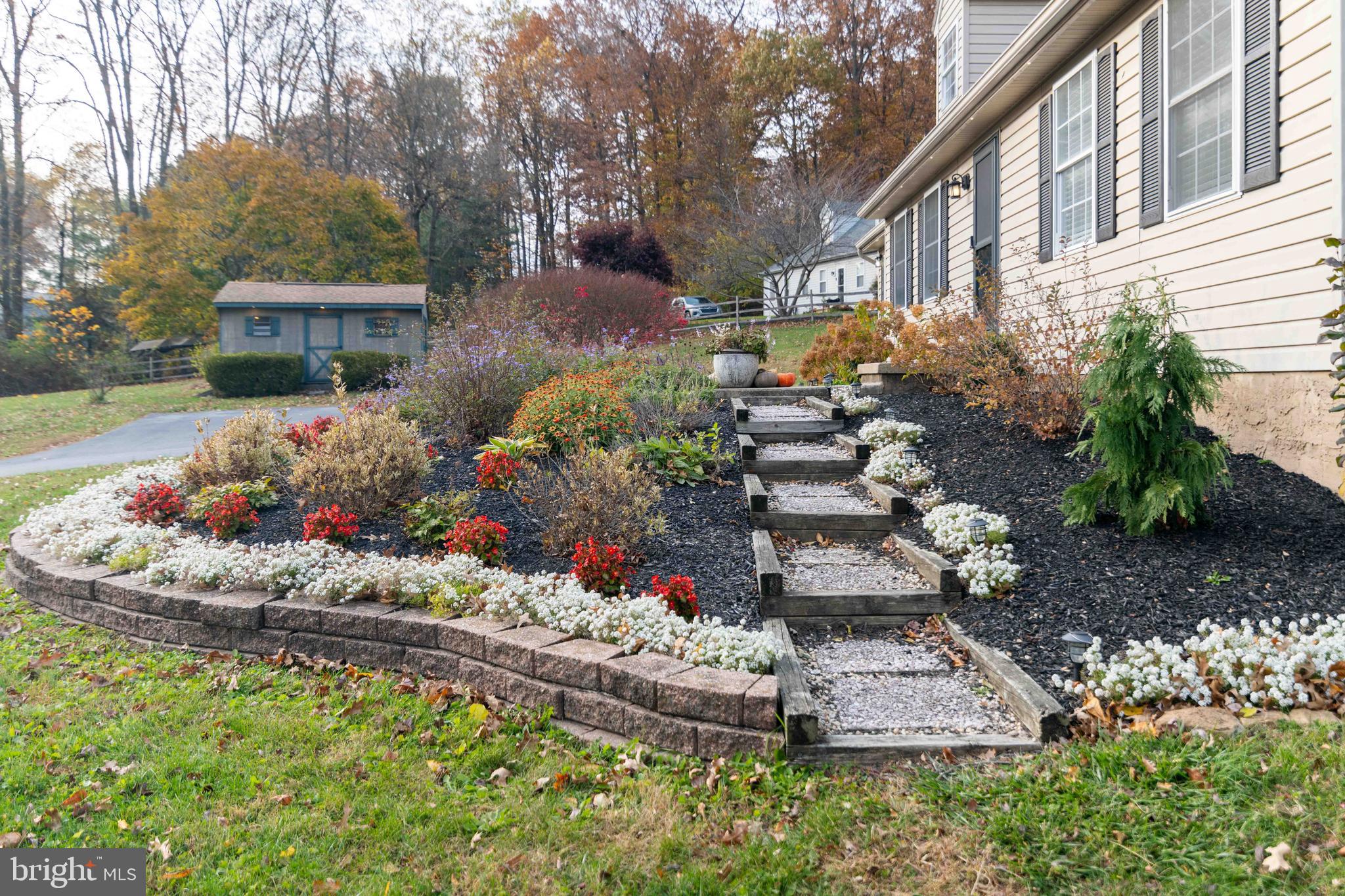 151 South Sandy Hill Road Coatesville, PA 19320 - Photo 68 of 91 a front view of a house with a yard and a garden