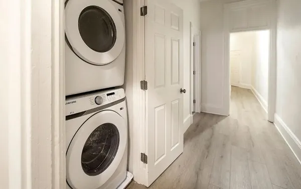 a view of a hallway with washer and dryer