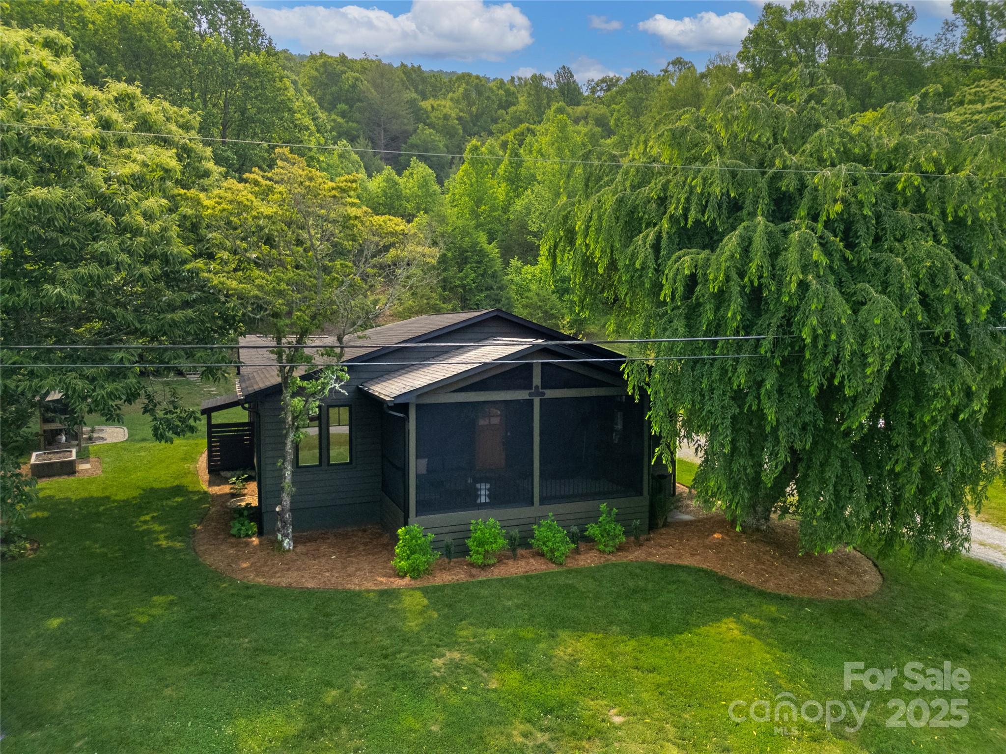 903 Middlefork Road Brevard, NC 28712 - Photo 1 of 45 a view of a chair and table in backyard of the house